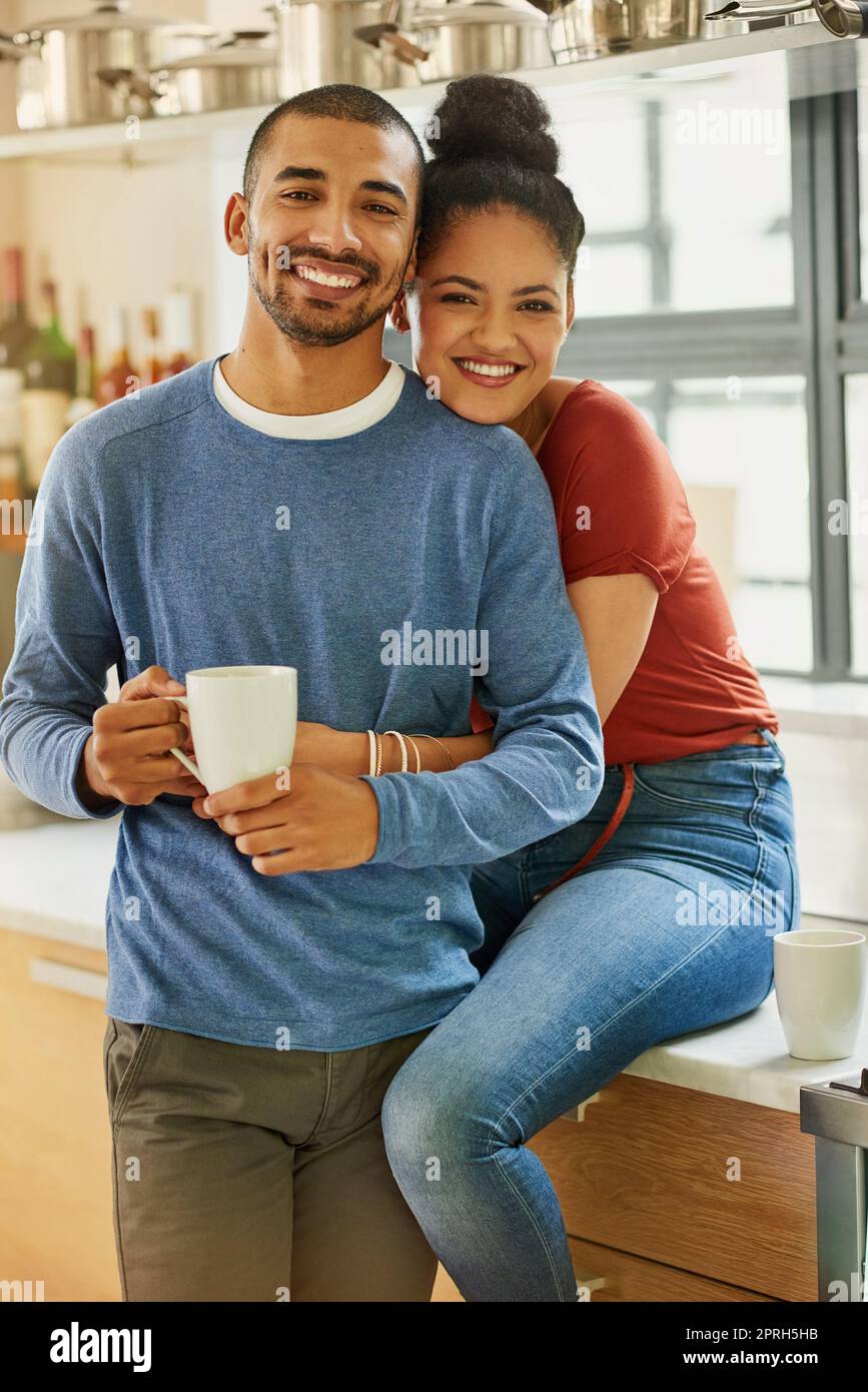 Marriage vibes. Portrait of a happy young couple embracing at home. Stock Photo