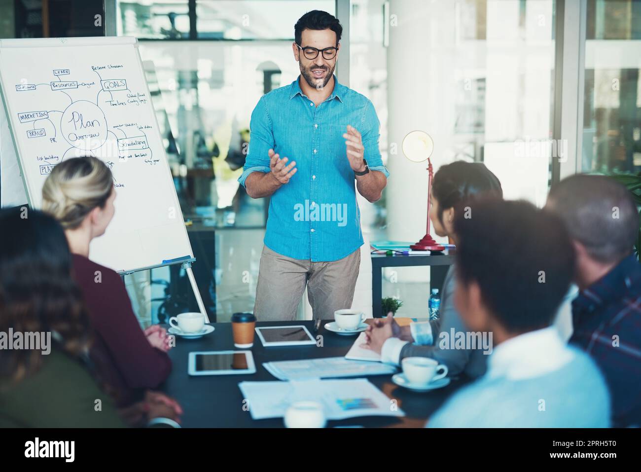 Presenting his ideas to the team. a young businessman giving a presentation. Stock Photo