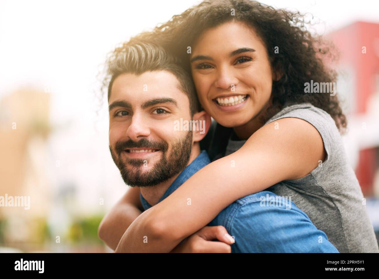 Shes not shy to crack an authentic smile. a playful couple out in the city together. Stock Photo