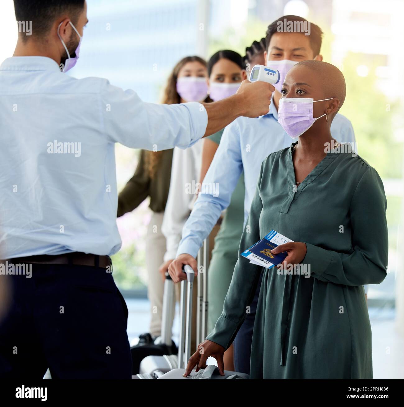 Airplane, global and people get covid test medical risk check for travel healthcare safety in airport. Compliance, man and women with transport tickets in face masks waiting in queue with luggage Stock Photo