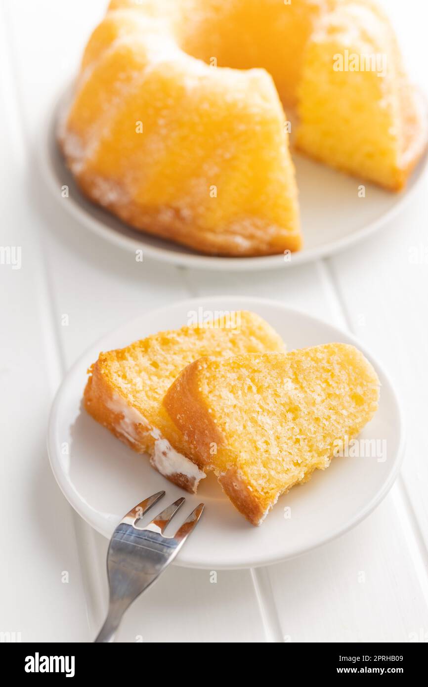 Sweet sponge cake. Bundt cake on plate on the white table Stock Photo