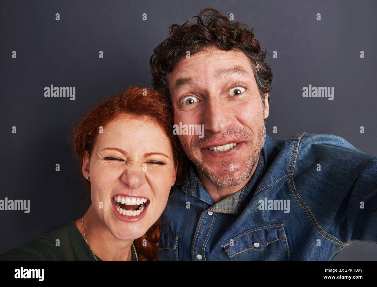 Winners of the couples silly face competition. Portrait of a happy young couple pulling silly faces for a selfie Stock Photo