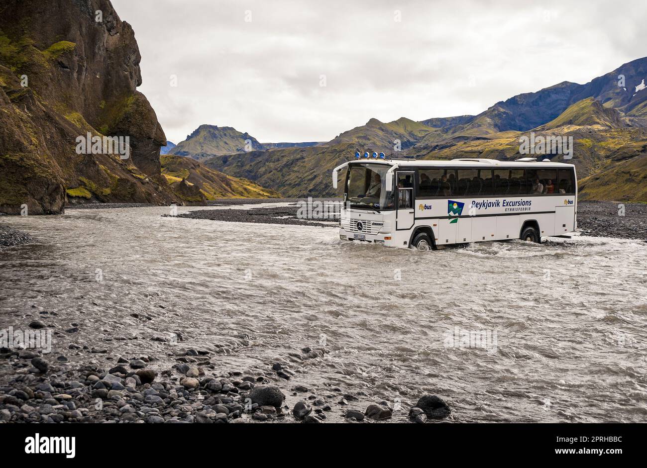 THORSMORK, ICELAND-September 1: Public bus crossing a river to take tourists into the wilderness of Iceland at Thorsmork, Iceland Stock Photo