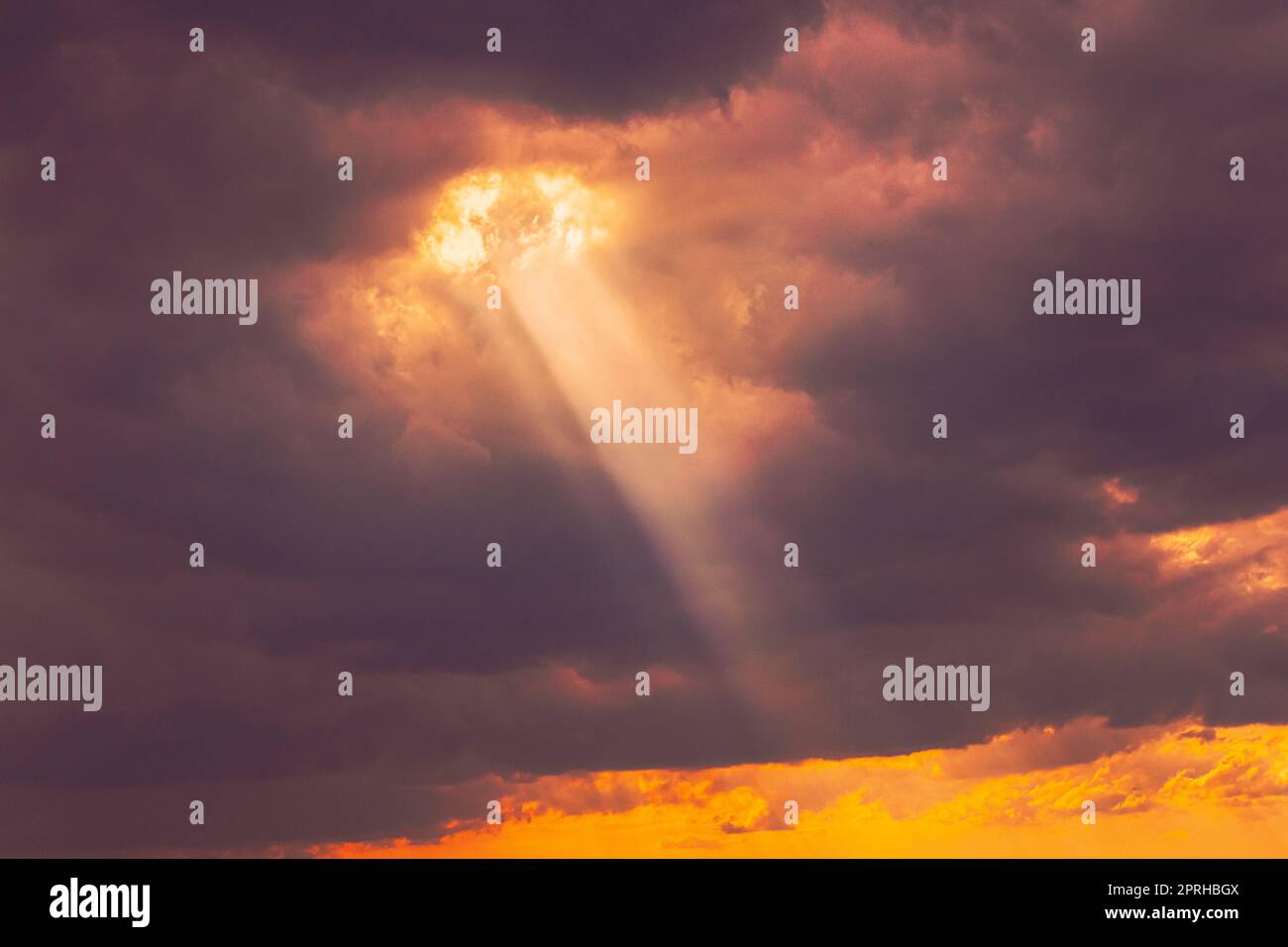 Sunshine In Sunrise Bright Dramatic Sky. Sun Ray Through Dark Rainy Clouds. Scenic Colorful Sky At Dawn. Sunset Sky Natural Abstract Background Stock Photo
