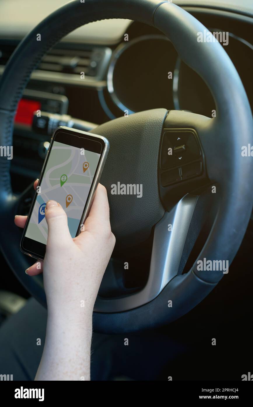 Staying on course with technology. a woman using her phones gps while