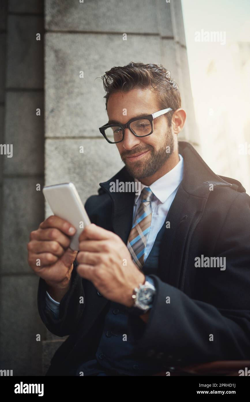 Staying in touch with modern life. a stylish man using his phone in the city. Stock Photo