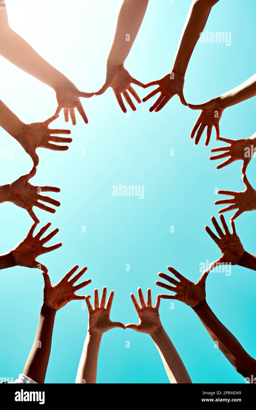 We all stand together. a group of unidentifiable businesspeople joining their hands in a gesture of unity. Stock Photo