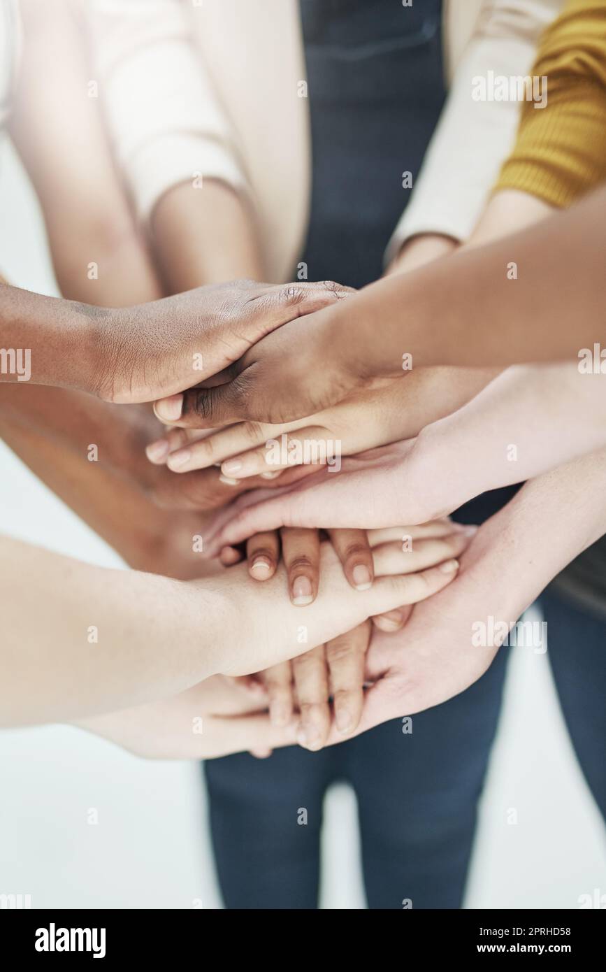 The spirit of teamwork. a group of people putting their hands together. Stock Photo