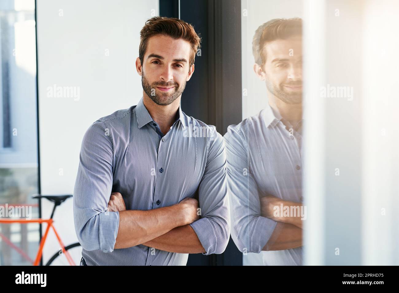 I did well for myself. a handsome young businessman in the office. Stock Photo