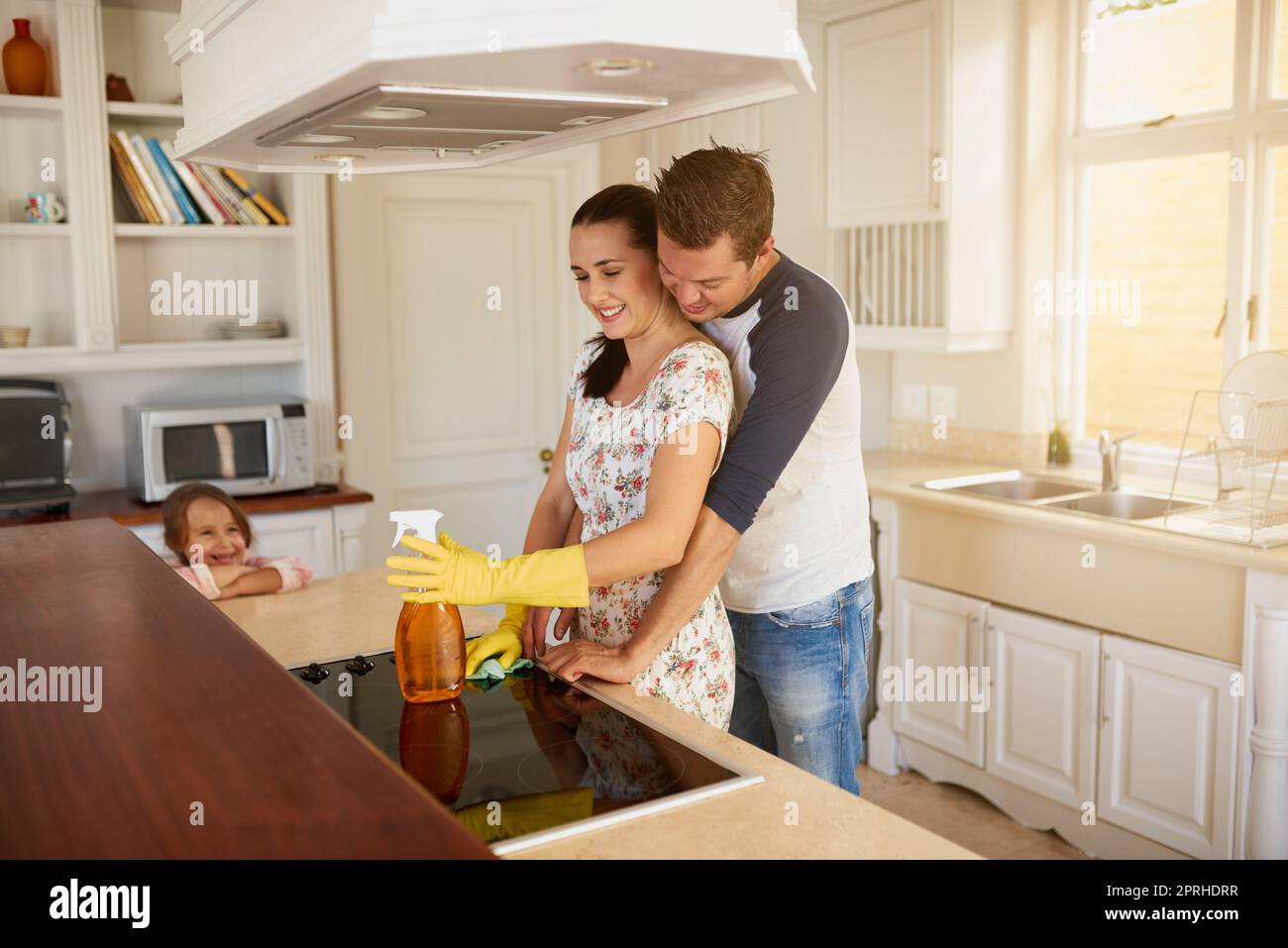 Sharing a moment. a happy family standing in a kitchen. Stock Photo