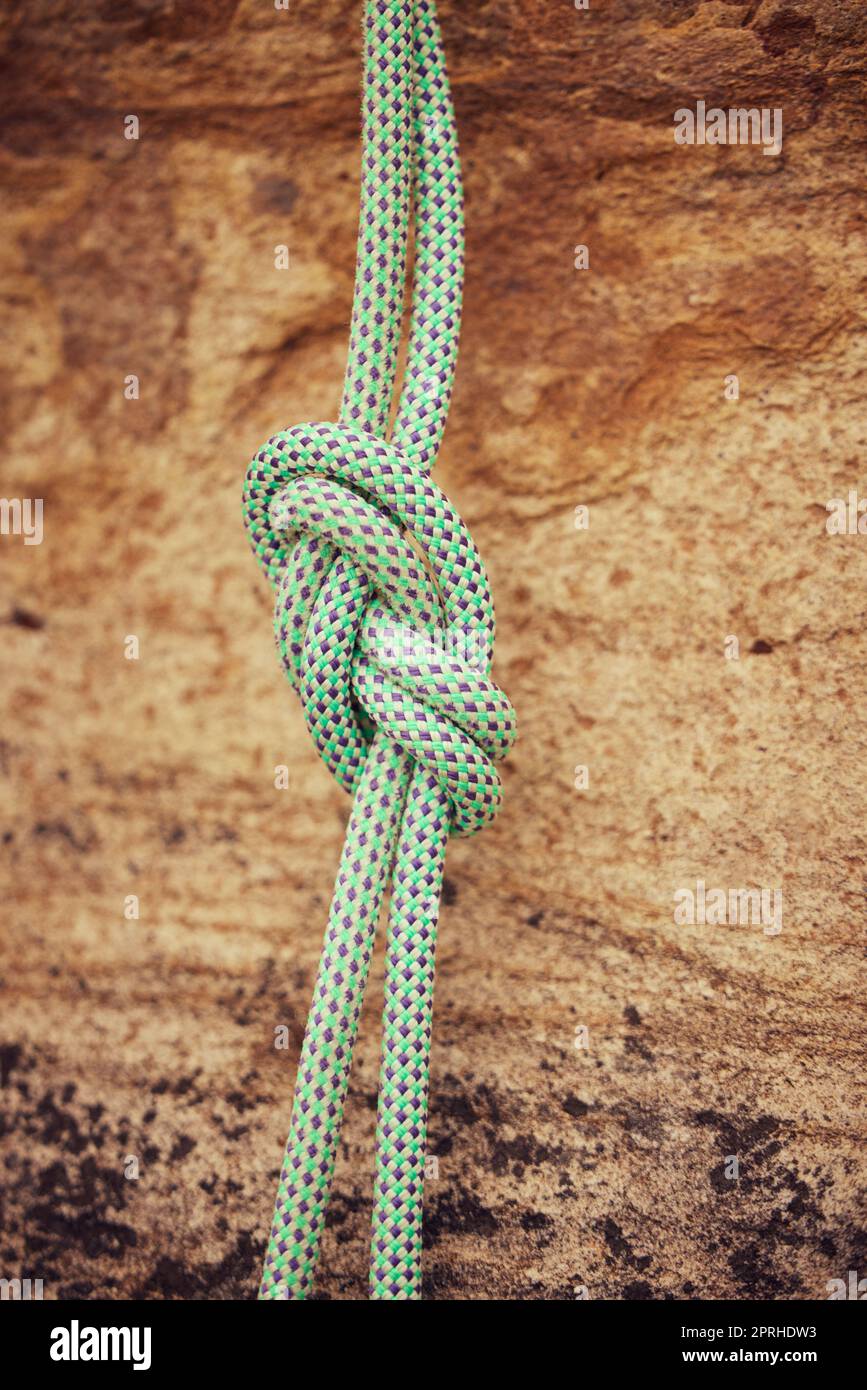 Safety, security and mountain climbing rope knot for helping on outdoor or  outside strong rock challenge fall risk danger. Fitness, exercise and train  Stock Photo - Alamy