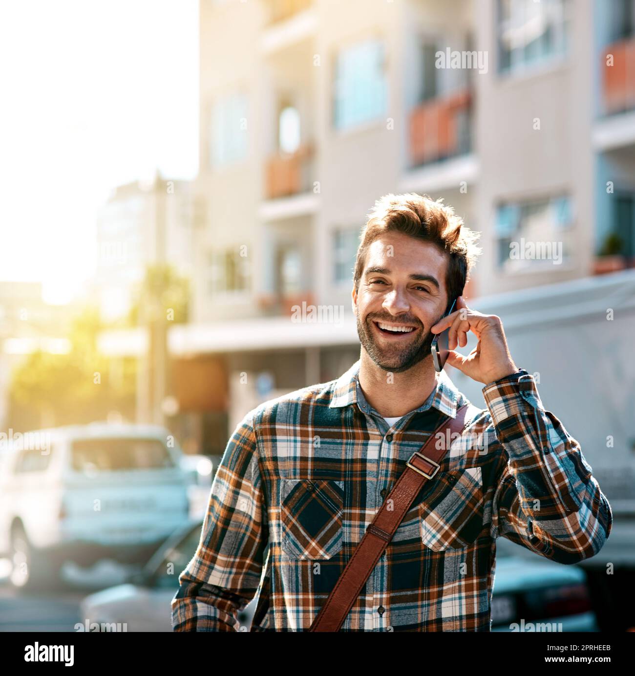 Im in town. Lets hook up. a handsome young man using his mobile phone while  out in the city Stock Photo - Alamy