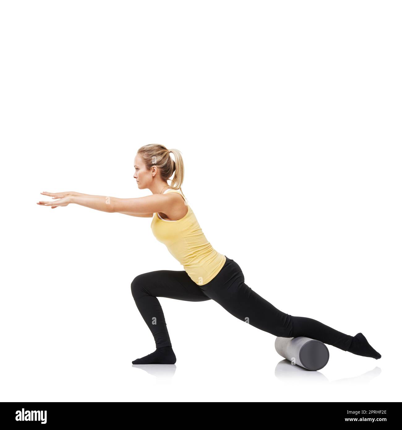 Lunging and stretching. A young woman performing lunges while using a