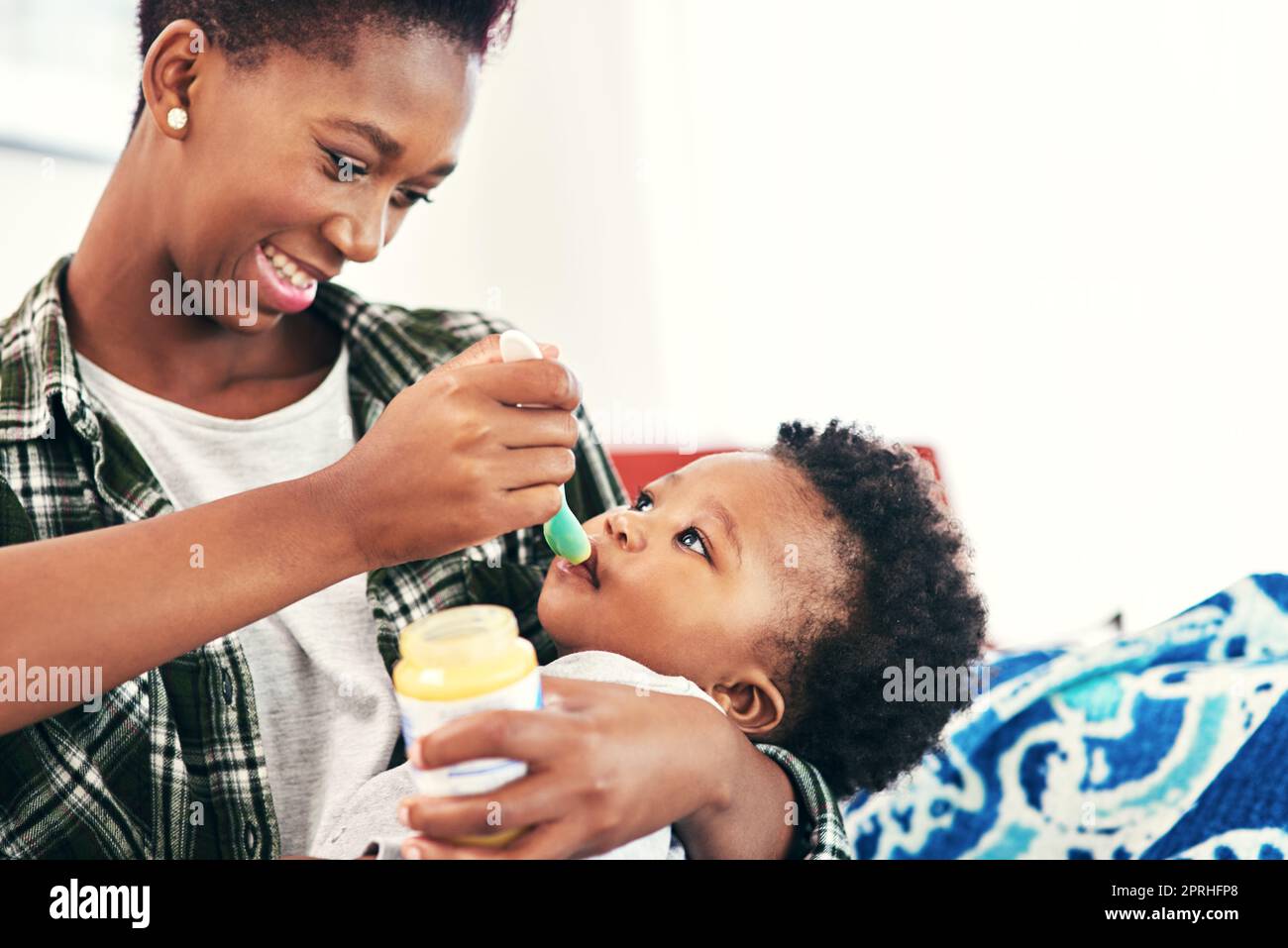 Words can not express the joy of new life. a mother feeding her little baby boy. Stock Photo