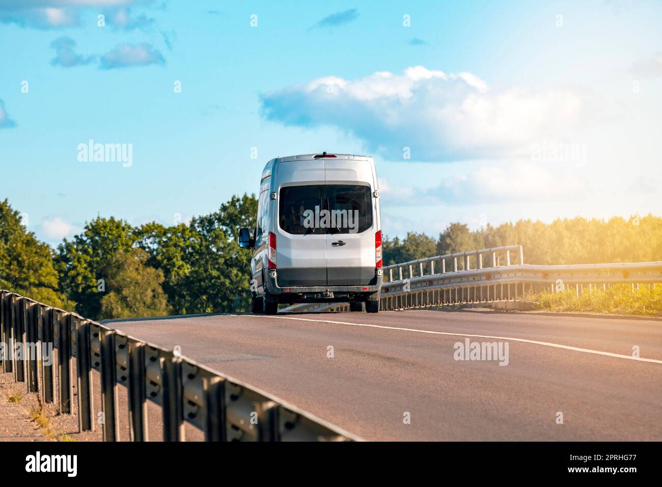 Car on the road with metal safety barrier or rail Stock Photo
