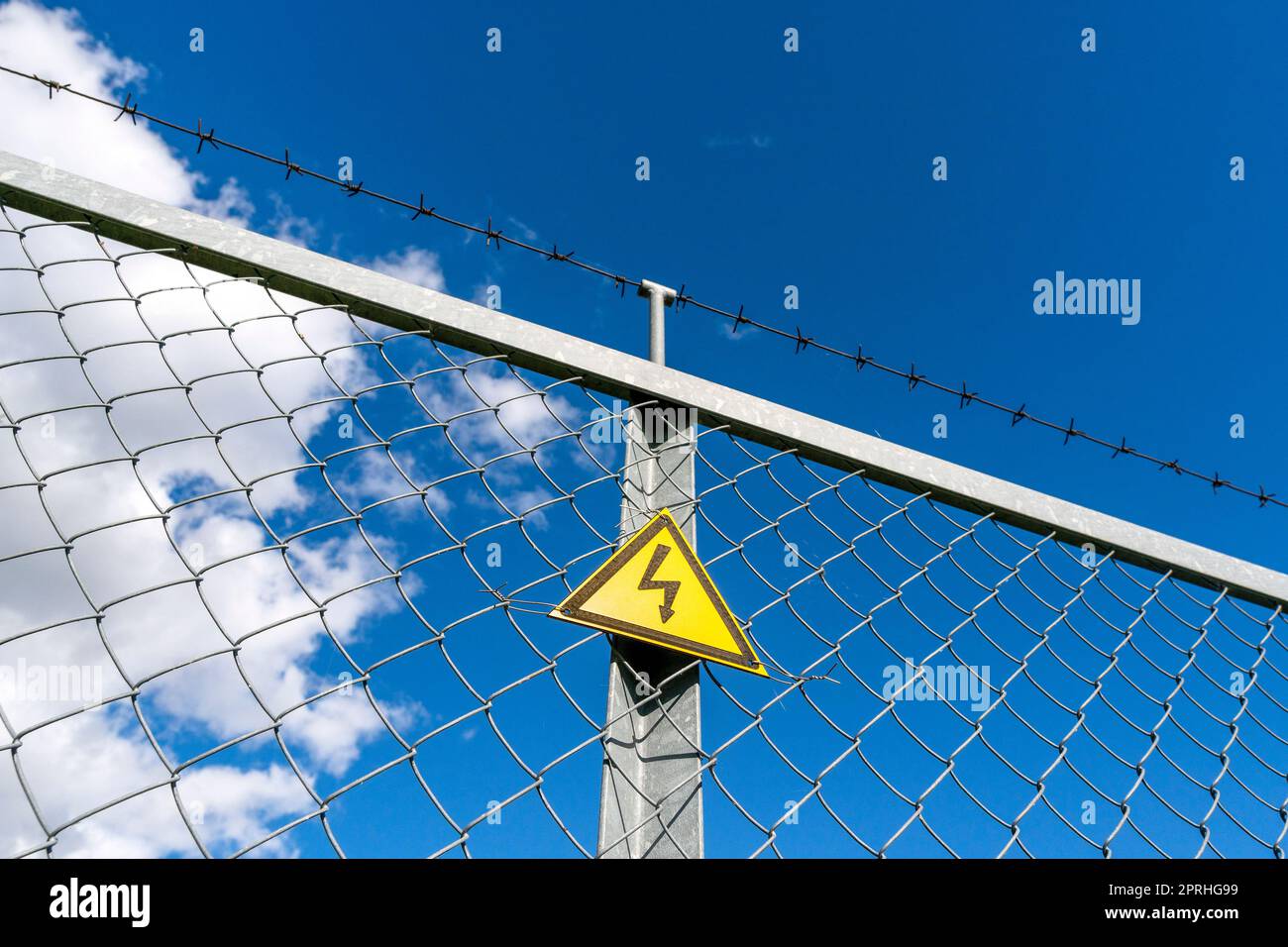 Warning sign danger on the fence Stock Photo