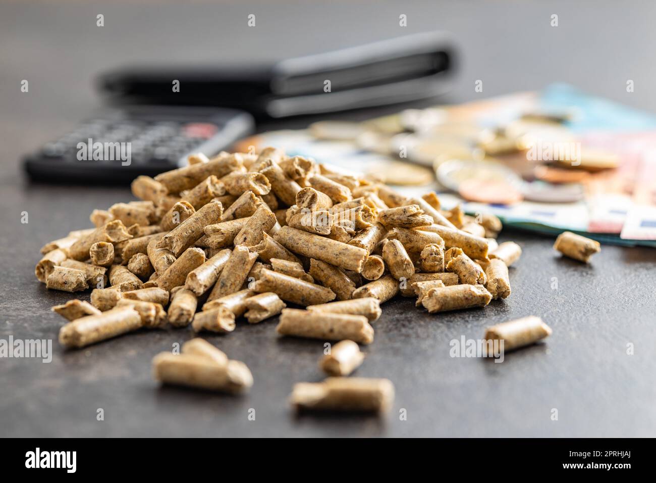 Wooden pellets, biofuel with euro money. Ecologic fuel made from biomass.  The renewable energy source Stock Photo - Alamy