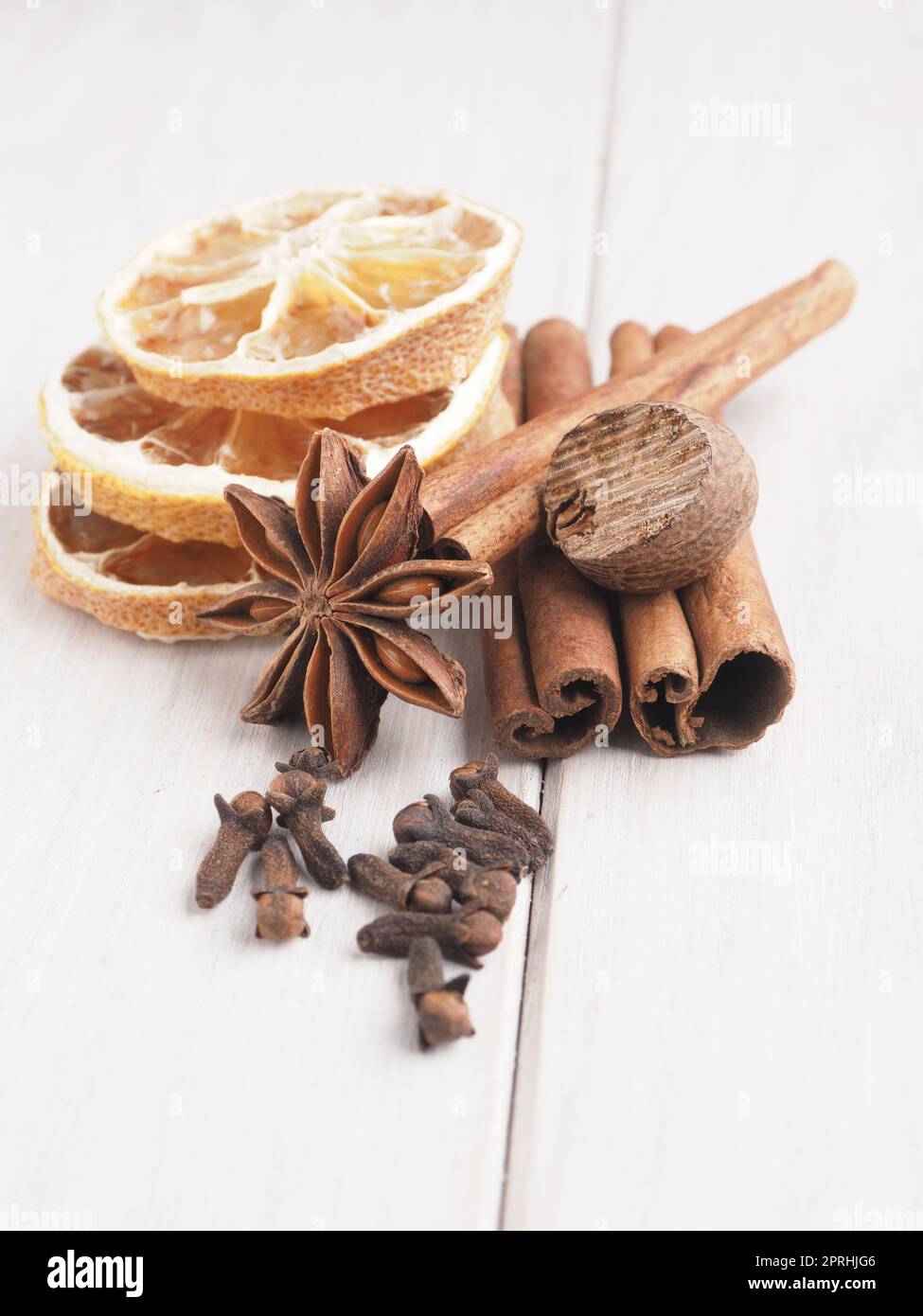 Different Christmas spices on a wooden table, seasonal food or ingredients Stock Photo