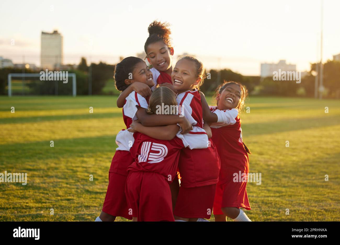 Celebration, winner and children soccer team happy for goal on the outdoor football field. Happiness, excited and sport friends playing girls football Stock Photo