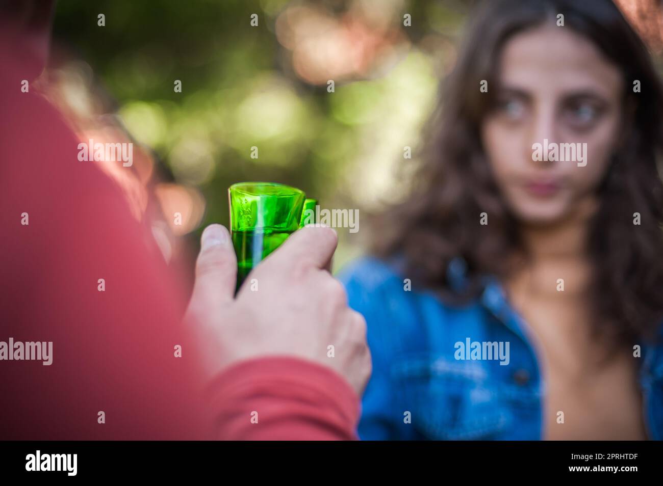 Very drunk couple, a boy and a girl, drink a strong alcoholic shot