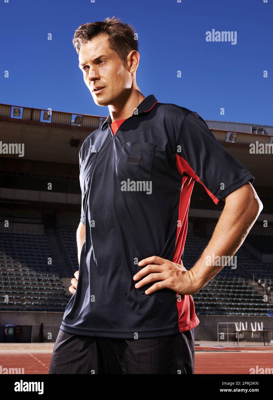 Confident before the game. A young athlete standing in the stadium ...