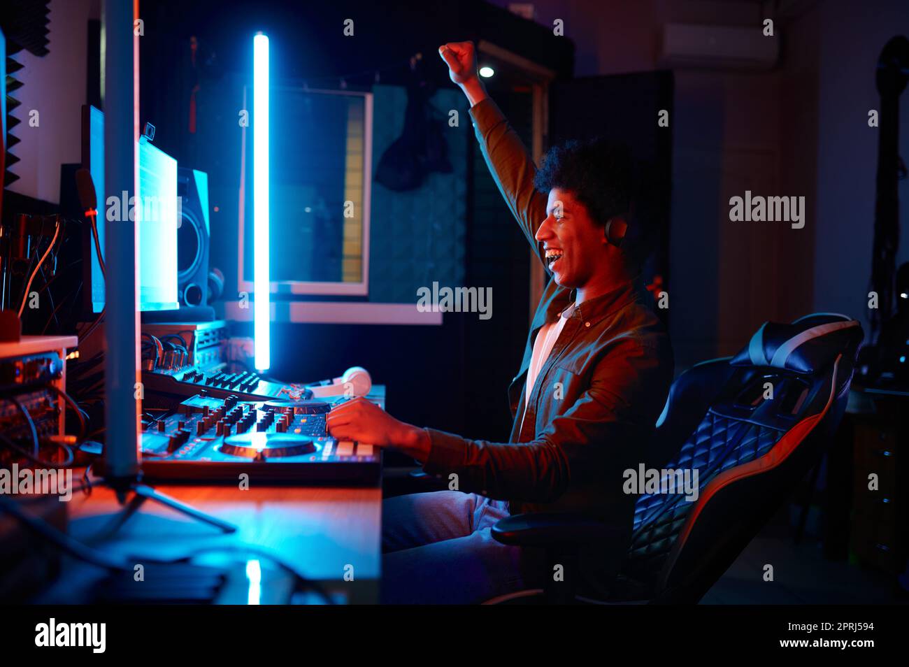 Emotional music sound producer at workplace side view, record studio or