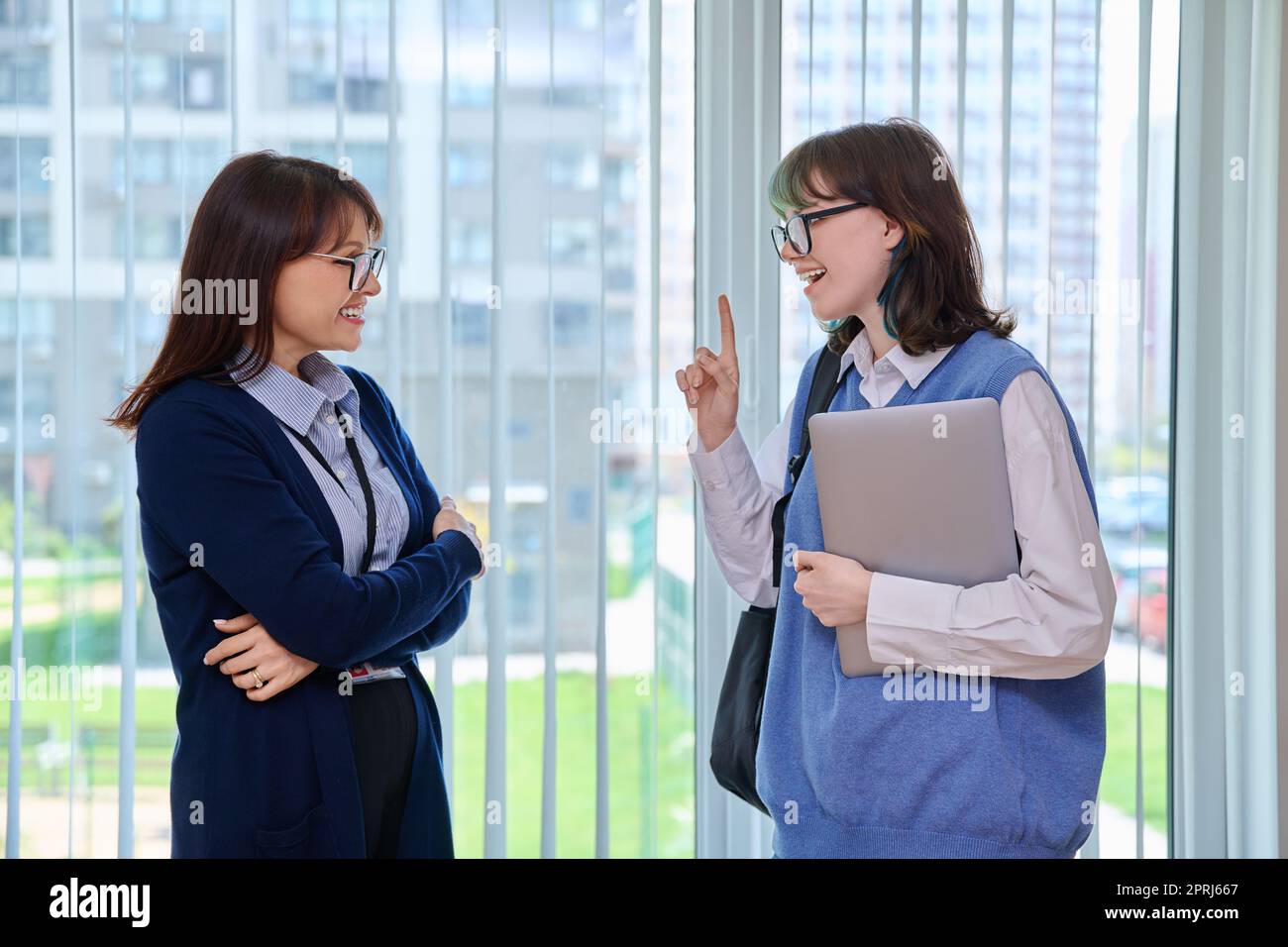 Meeting, conversation of female teacher and girl college student in ...