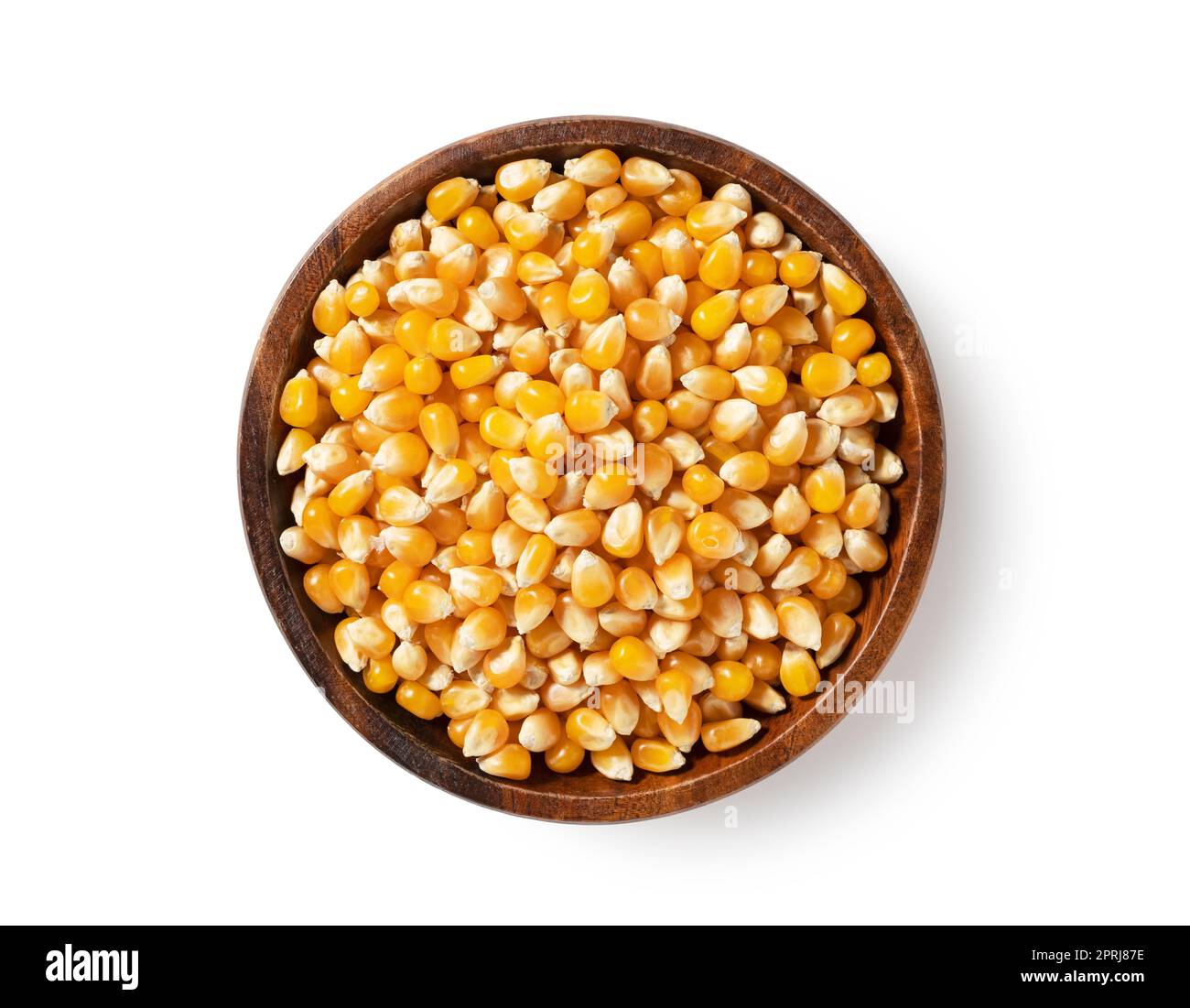 Dried corn kernels in wooden bowl placed on white background. Corn for