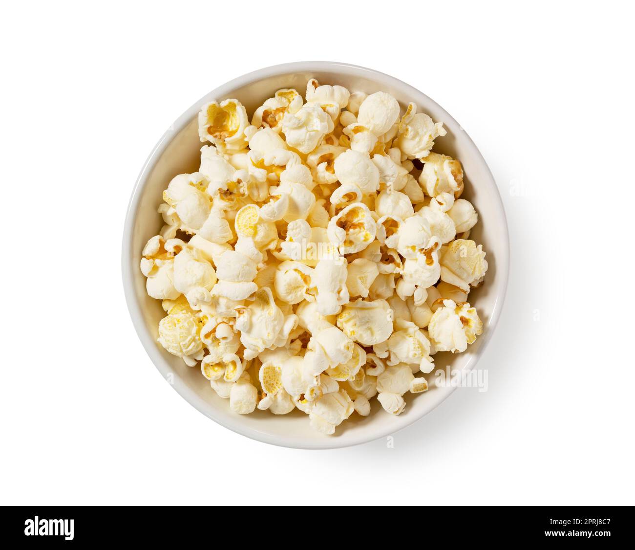 Popcorn in a white bowl placed on a white background. Stock Photo