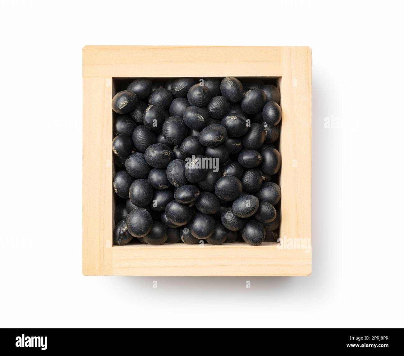 Black soybeans in a masu placed against a white background. Black