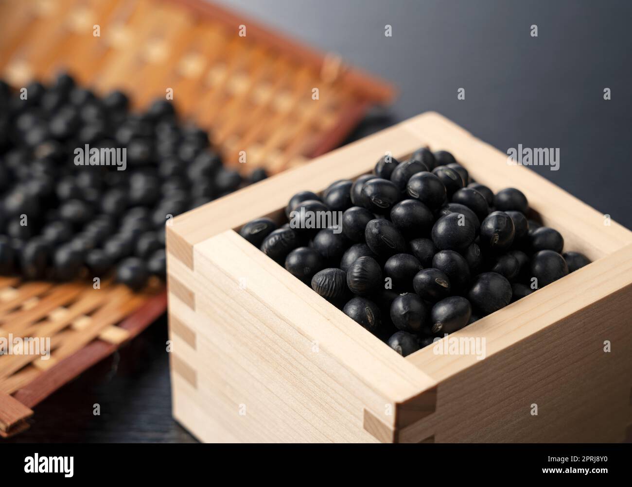 Black soybeans in a square on a black background. Black soybeans Stock