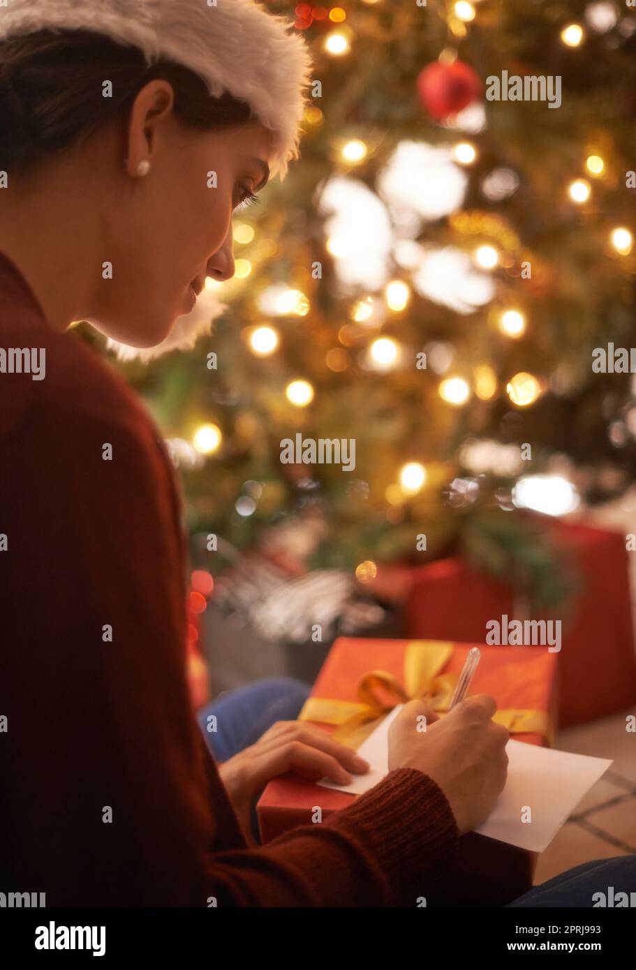 Twas the night before christmas. A young woman at home at Christmas time Stock Photo