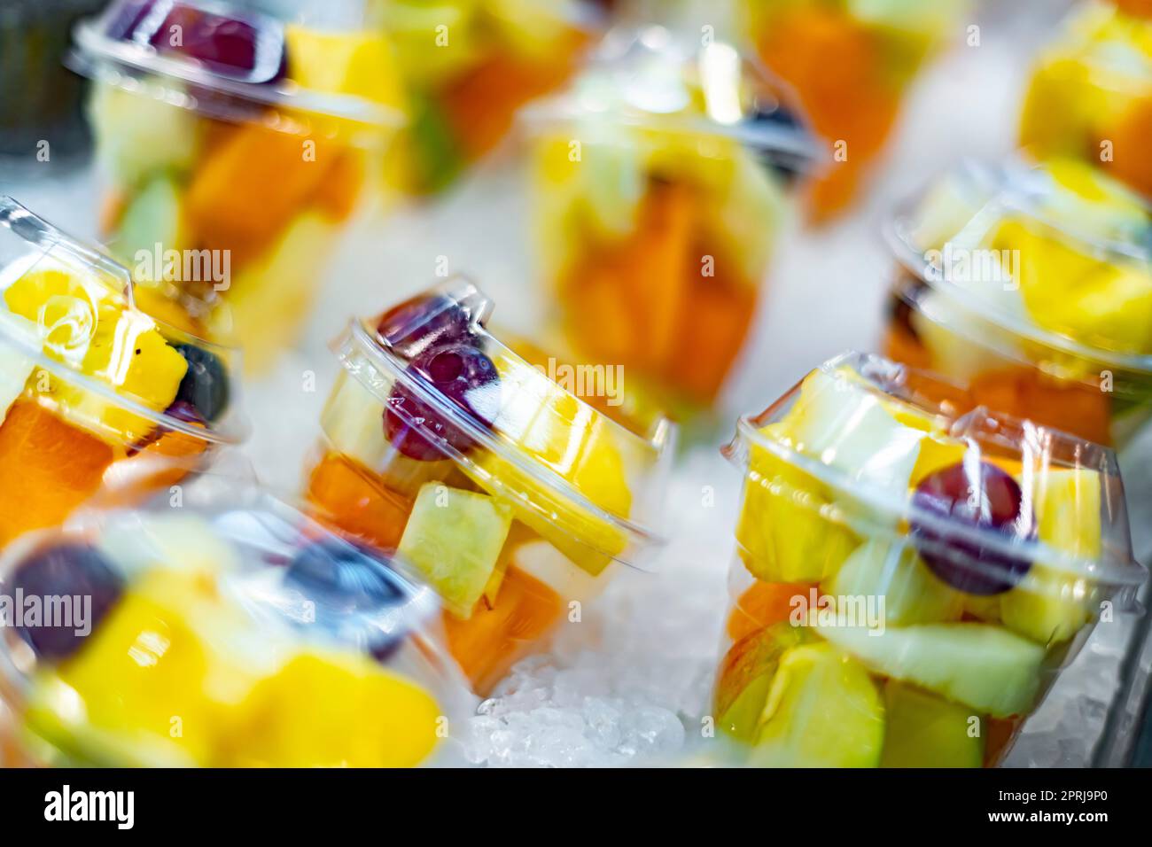 Prepackaged fruit salads displayed in a commercial refrigerator Stock