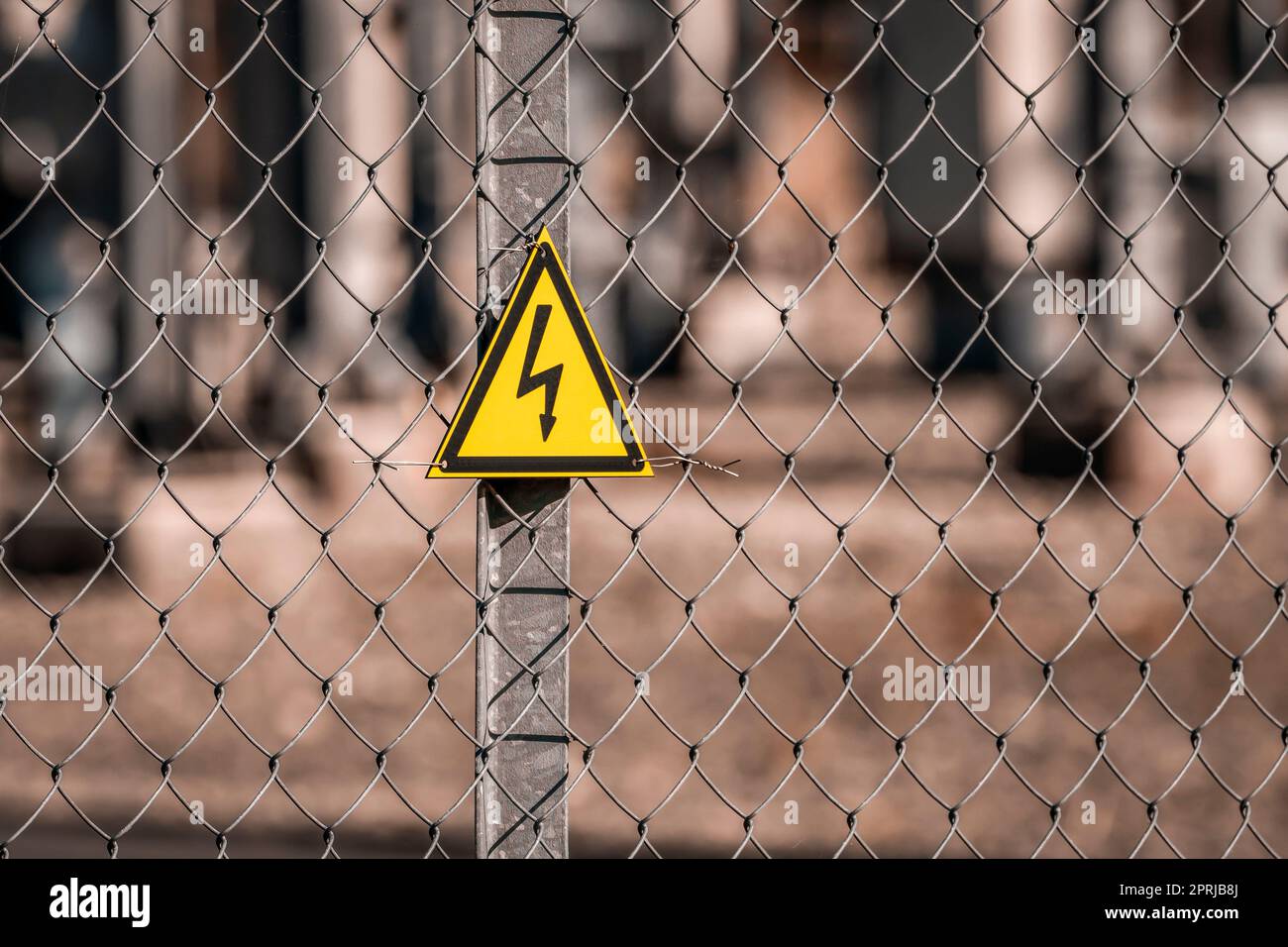 Electrical hazard sign placed on a fence of an electrical substation Stock Photo