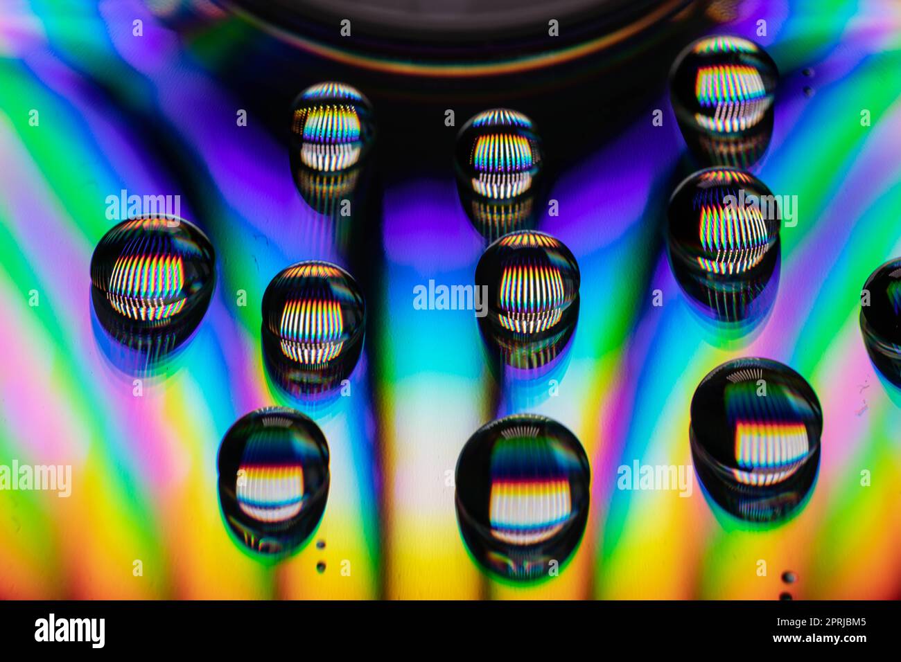 Drops of water on a CD create an explosion of color and a rush for the senses Stock Photo