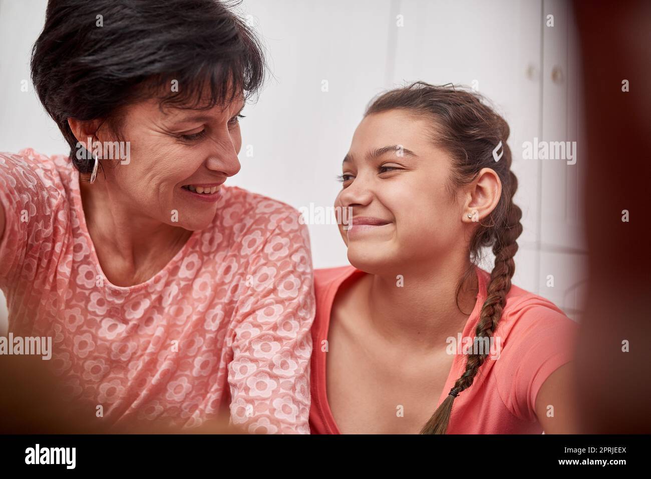 They share a special bond. a mother and daughter smiling at each other. Stock Photo
