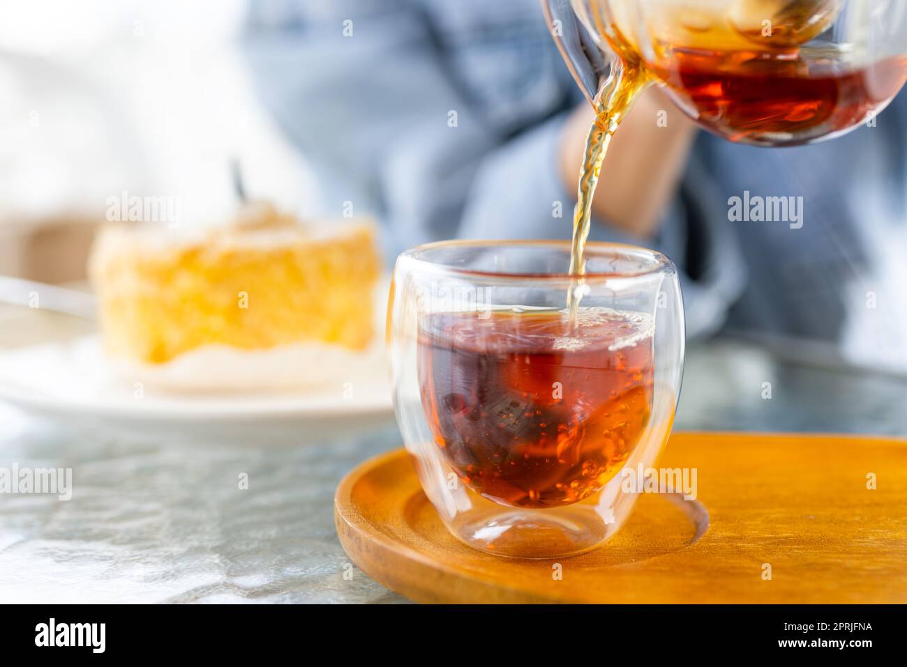Pouring hot tea at outdoor cafe Stock Photo