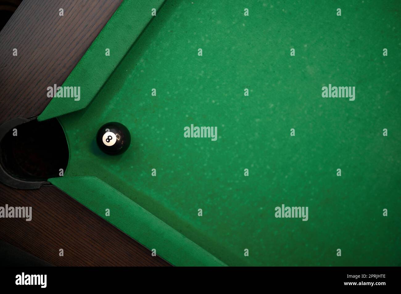 Ball at pool pocket rolling into in billiard table corner, view from above Stock Photo Alamy