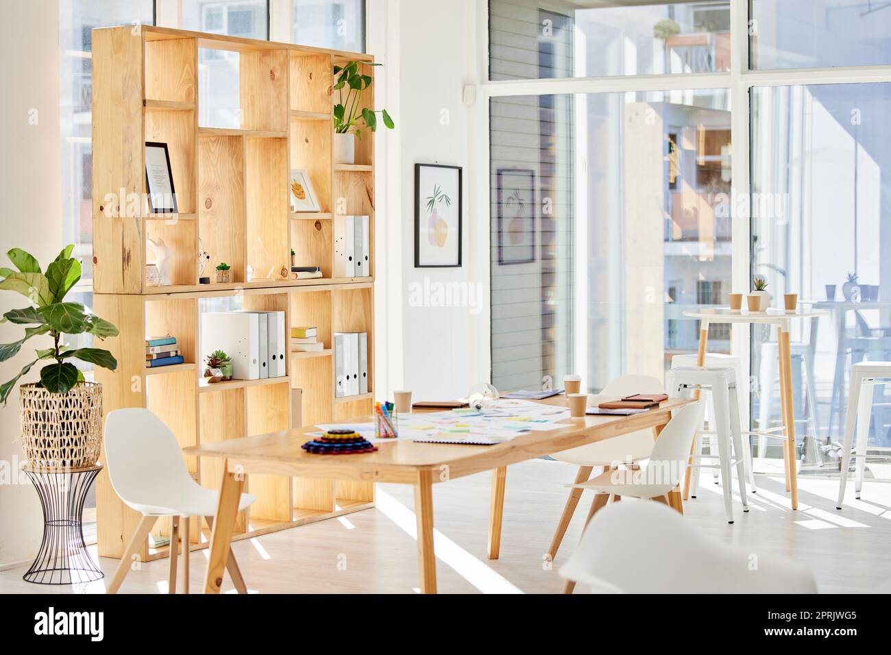 Aesthetic interior of home office interior with design chair, wooden desk,  plants, shelf, office accessories, post cards, photos and decoration.  Minimalist home decor. Template. Photos
