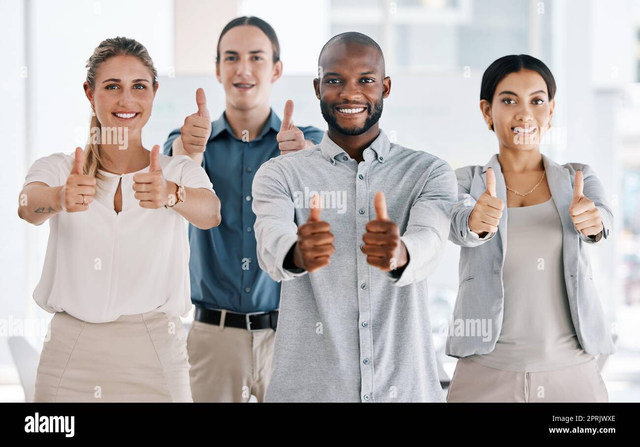 Diversity, team and thumbs up of business people in teamwork agreement for success at the office. Group of diverse employee workers together in collaboration in agree, yes or thank you hand gestures Stock Photo