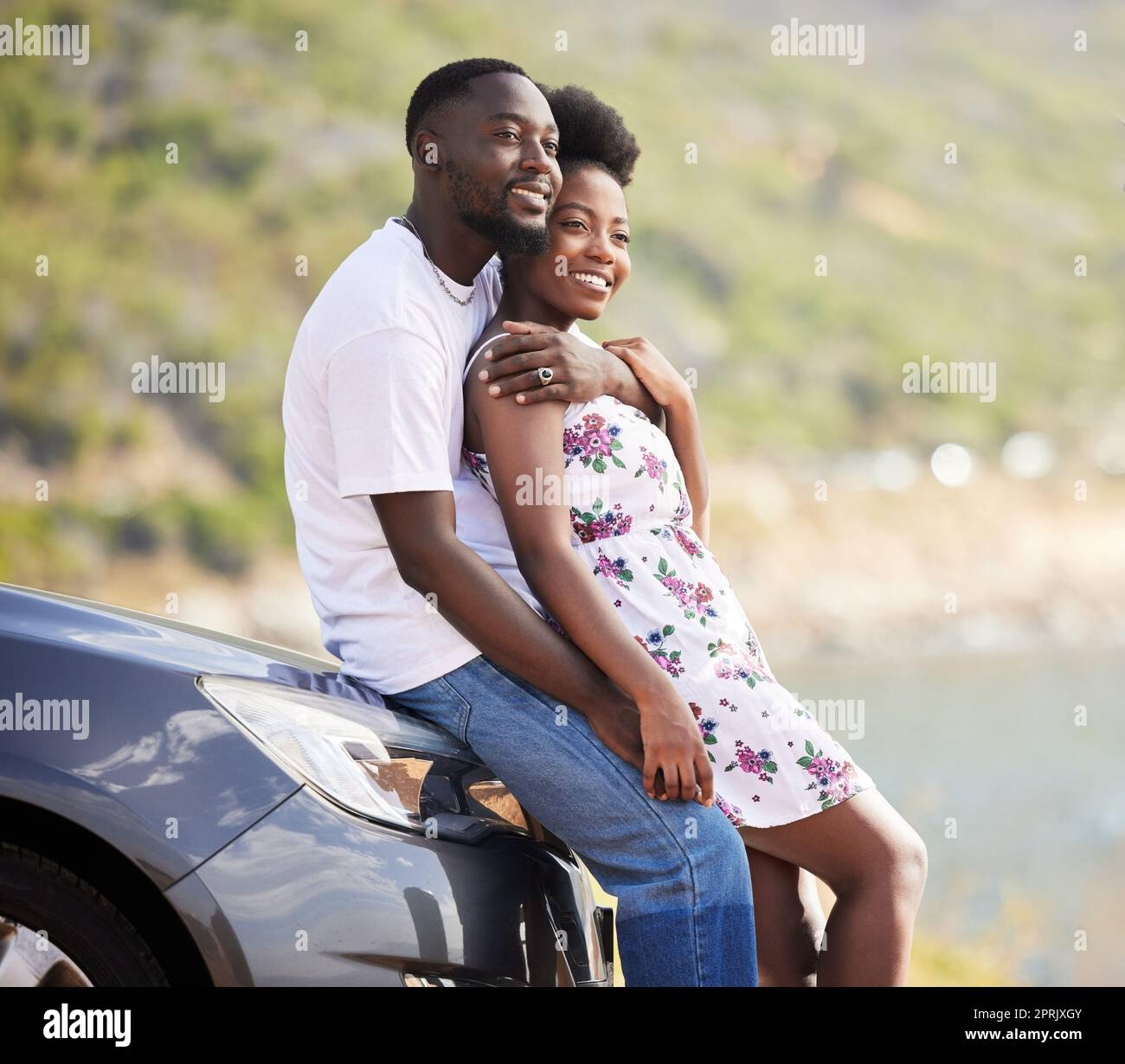 Road trip couple parking with love, hug and looking at nature getaway, green natural environment or mountain roadside. Happy, romantic and dating young man and woman travel together near countryside Stock Photo