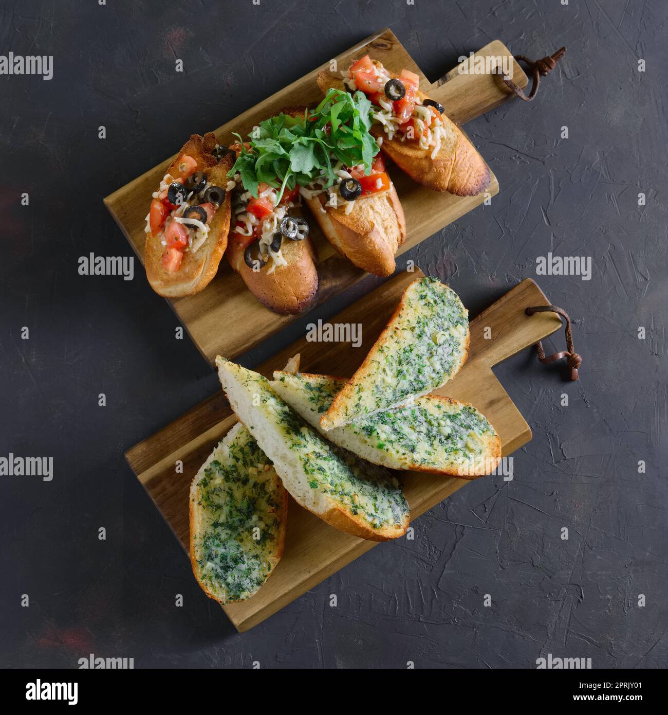 Set of toasts with tomato, onion, cheese, arugula, basil, olives Stock Photo