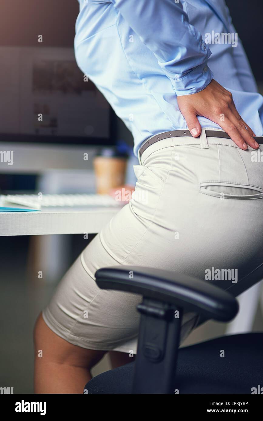 Woman having pain, muscle or chronic nerve pain in her back, sitting on  chair. Diseases of musculoskeletal system, spine, scoliosis, osteoporosis  Stock Photo - Alamy