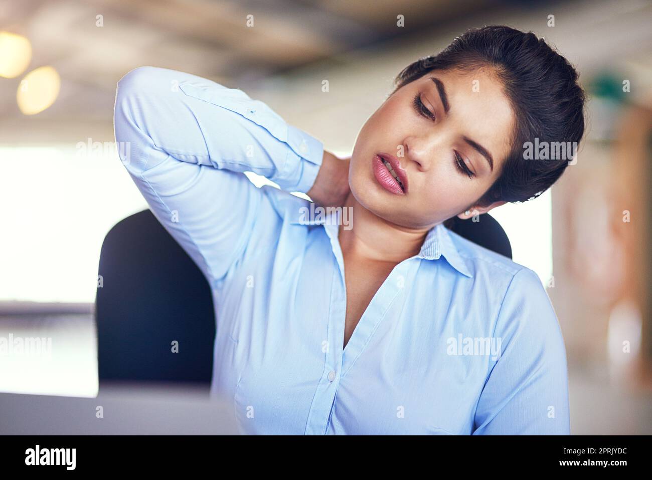 My poor neck muscles...a young businesswoman suffering from neck pain