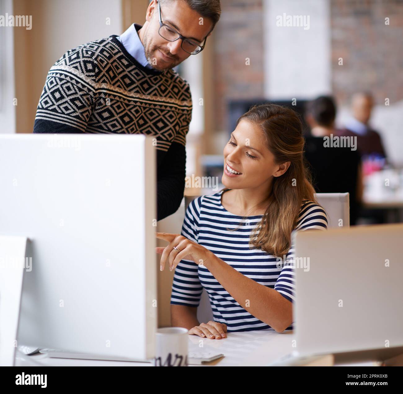 Bouncing ideas off of each other. two designers working together at a computer. Stock Photo
