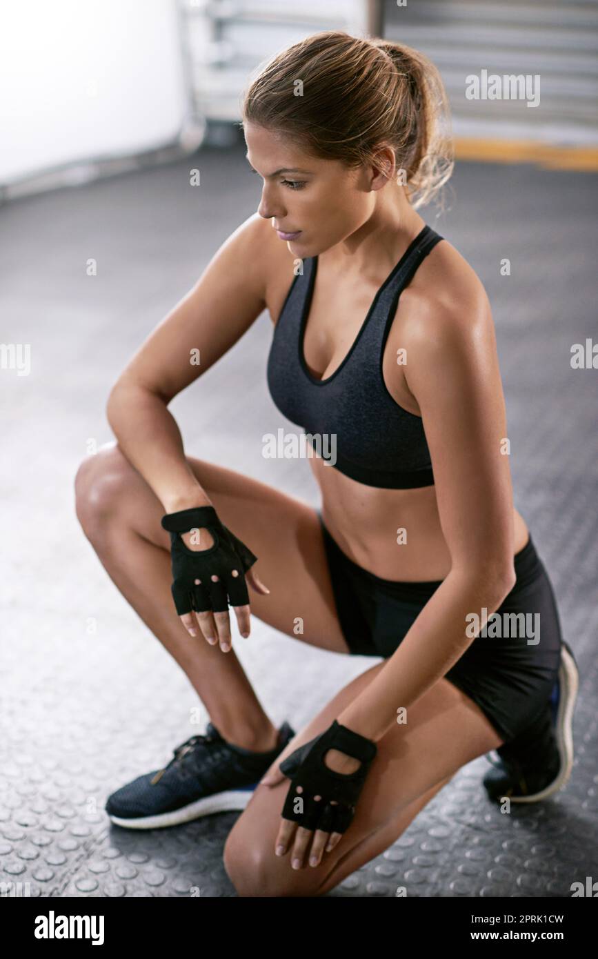 Determined to reach her fitness goals. a young woman working out in the gym. Stock Photo