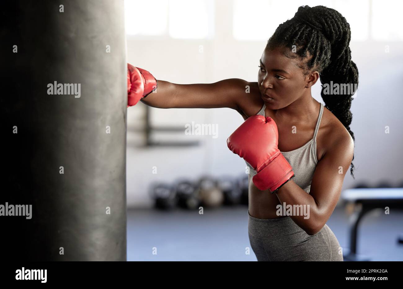 Boxer, workout and training girl with punching bag working on sports