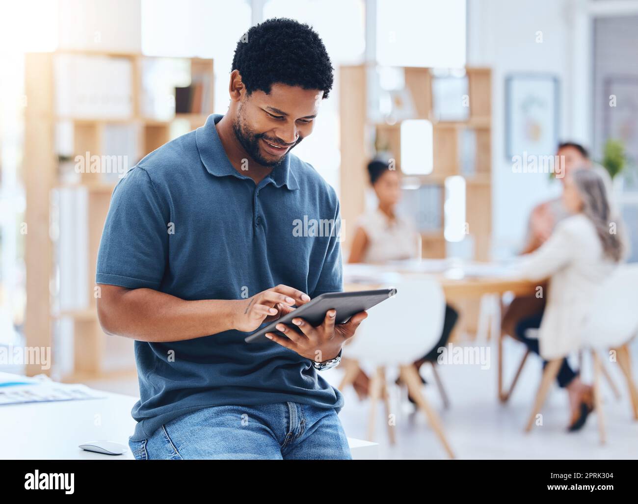 Black man business planning online digital tablet, internet and web apps technology in startup agency. Happy entrepreneur, smile creative worker and african designer connect 5g wifi in trendy office Stock Photo