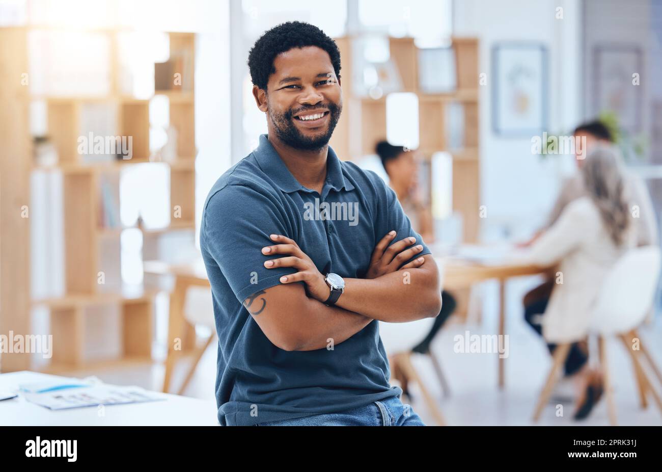 Business meeting, black man and smile portrait with arms crossed at coworking conference desk. Casual corporate male with proud, confident and happy expression at office building boardroom. Stock Photo