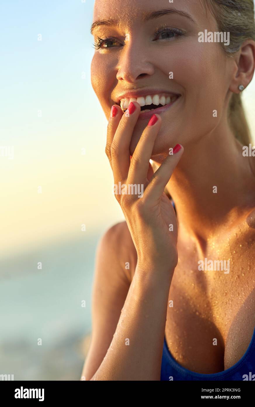 Feeling positivie about her workout. a sporty young woman standing outdoors. Stock Photo